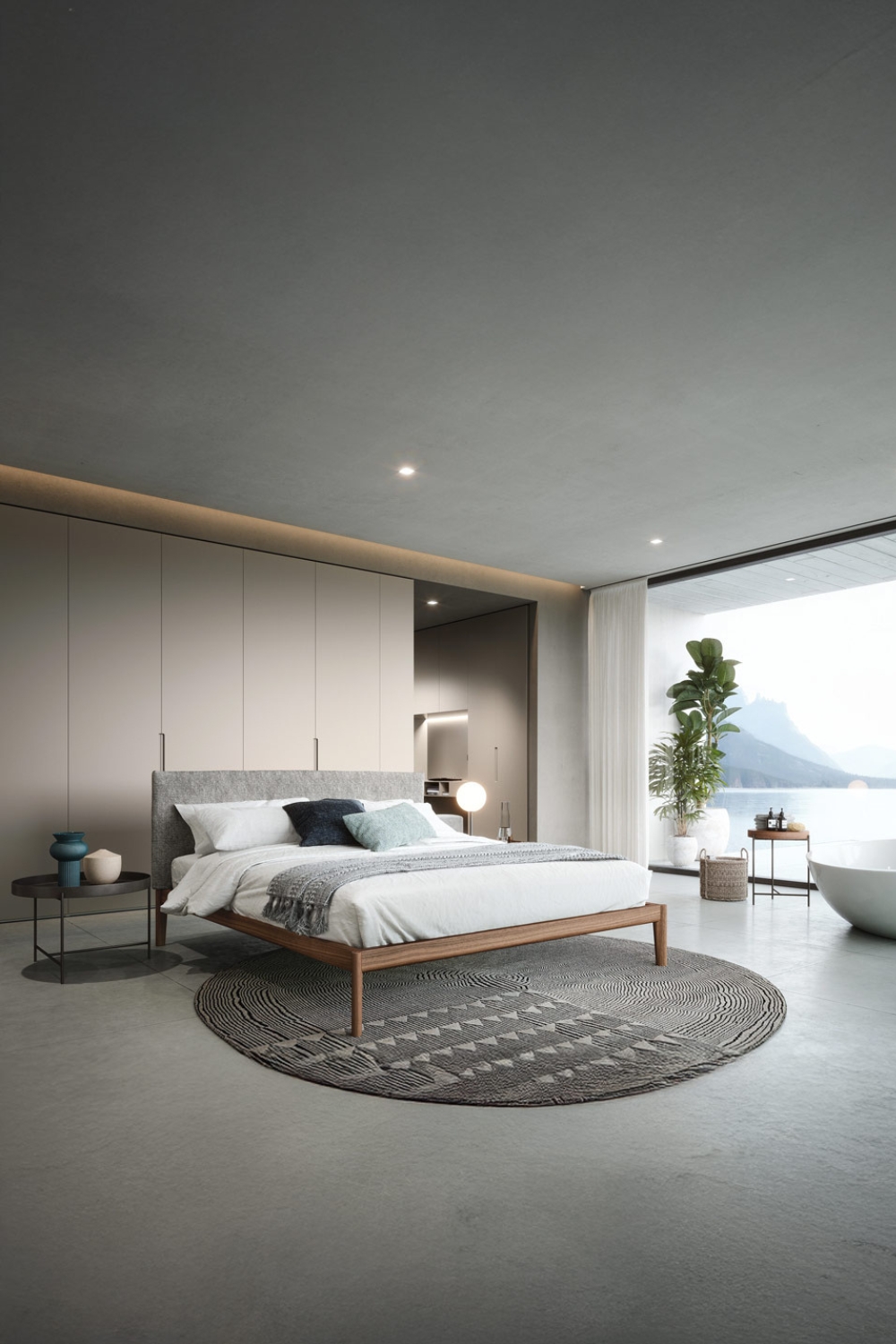 bett-und-kleiderschrank-mit-geradliniger-designsprache-in-einem-geraeumigen-schlafzimmer-mit-grosser-fensterfront