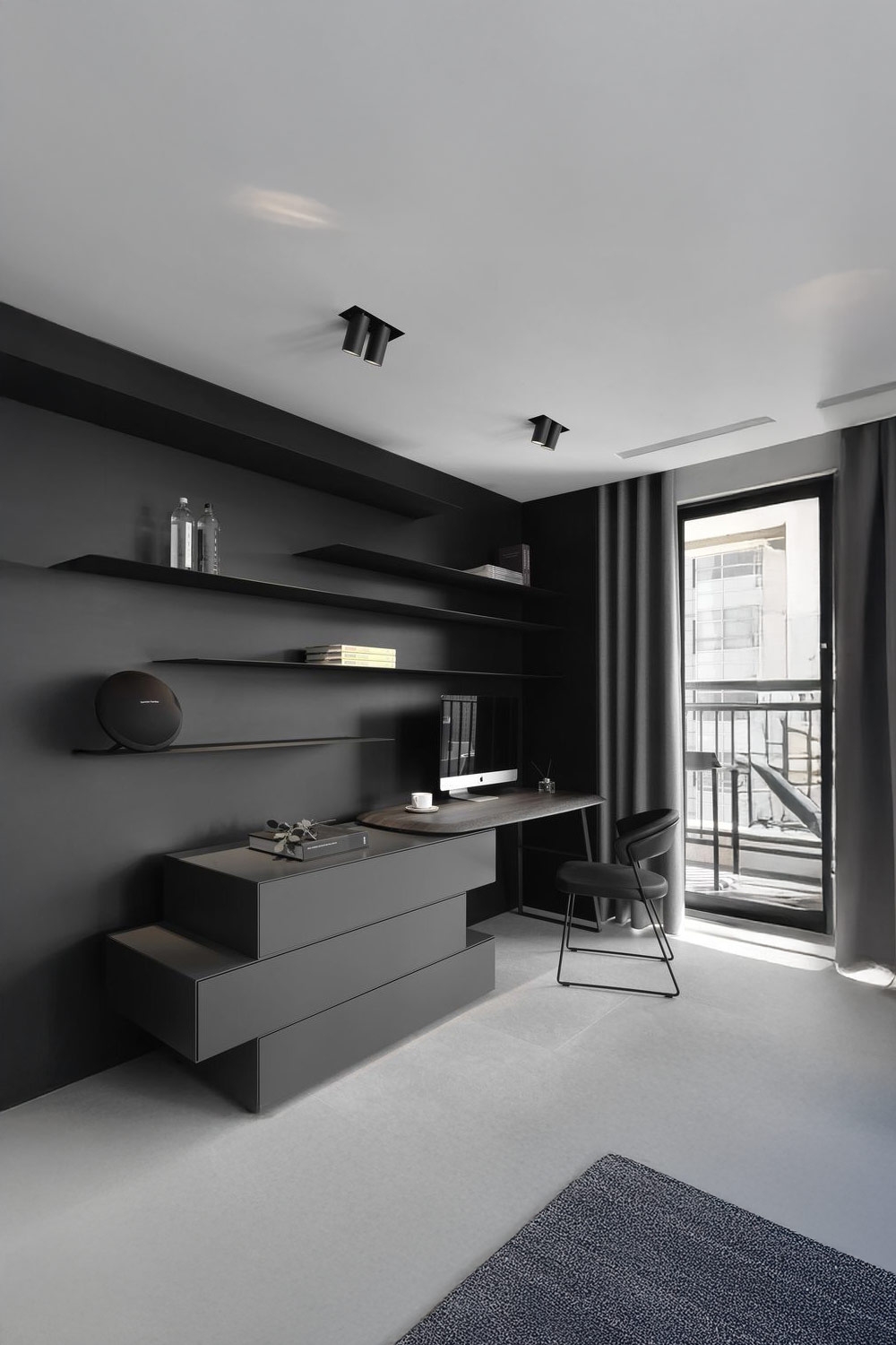 dunkelgrau-eingerichtetes-arbeitszimmer-mit-versetzten-schubladen-und-regalen