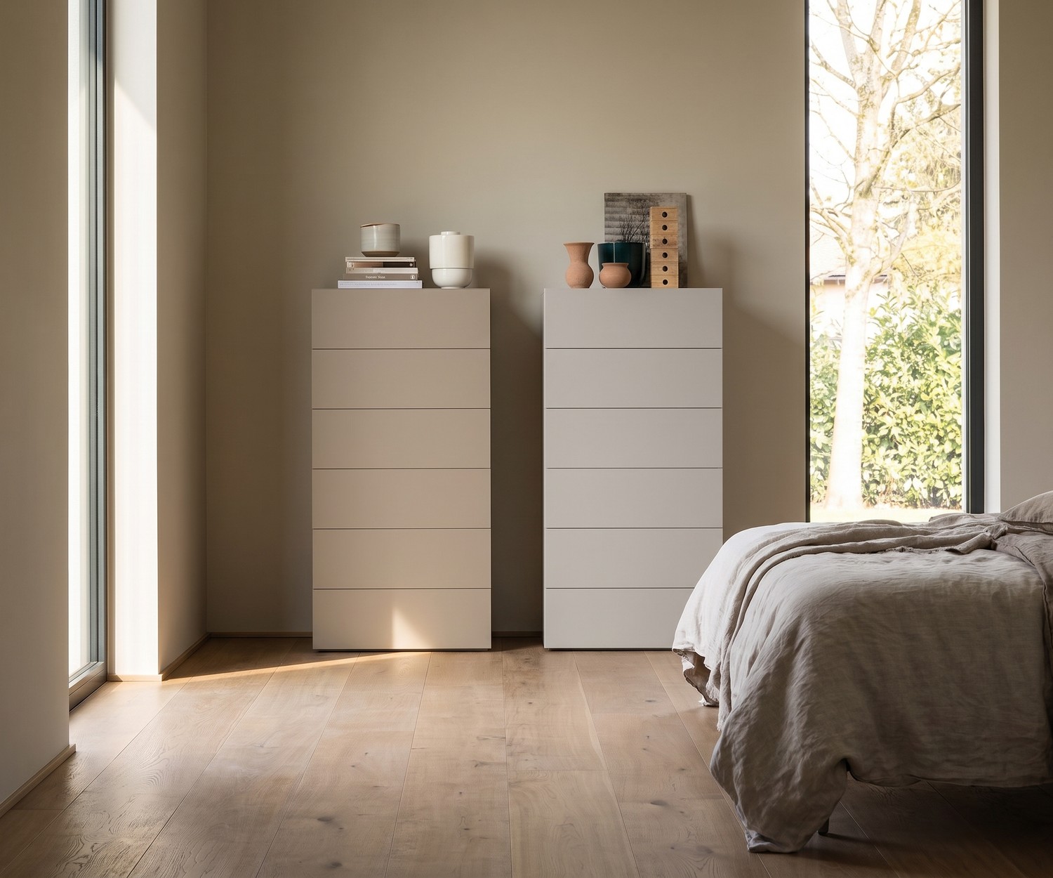Novamobili Hochkommode Easy mit 6 Schubladen Hochkommode Easy für das Schlafzimmer mit 6 Schubladen. Moderne grifflose Design-Kommode in Beige und Grau vor beiger Wand.
